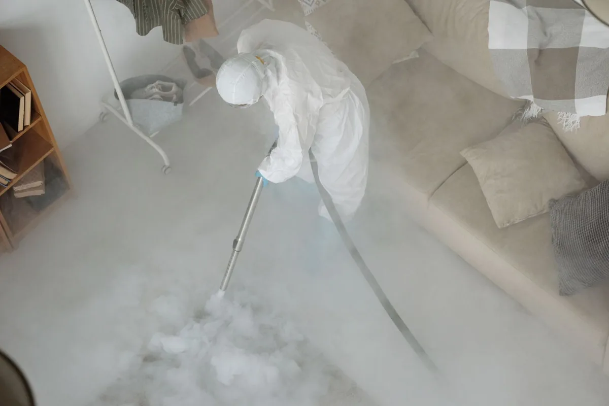 Biohazard cleanup technician in protective equipment, Hays, KS